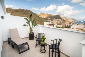 a balcony with chairs and a view of the city at Barceló Santa Cruz Contemporáneo in Santa Cruz de Tenerife +204 photos