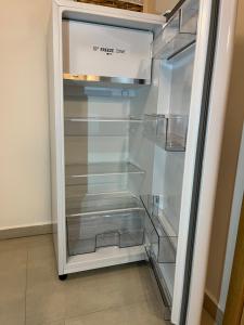 an empty refrigerator with its door open in a room at Apartmán Blatka in Nová Pec