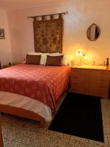 a bedroom with a bed and a dresser and a mirror at Casa di Marie in Mafalda