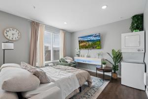 a bedroom with a bed and a sink and a clock at Valclyde Elevated Urban Haven in Minneapolis +9 photos
