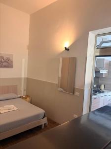 a small room with a bed and a kitchen at marsala centro storico in Marsala +20 photos