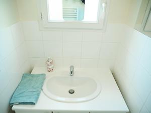 a bathroom with a white sink and a mirror at L'ESCAPADE T3 avec terrasse privative in Lussac-les-Châteaux +14 photos