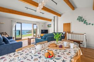 a living room with a table with food on it at House 43 in Looe