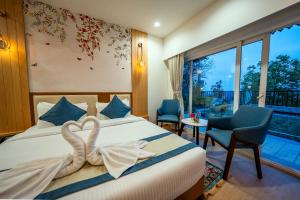 a hotel room with a bed with a heart decoration on it at Arkaya Mukteshwar by SuperGlitz Resorts Pvt Ltd in Mukteshwar