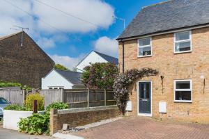 a brick house with a fence at Gerald's Place in Deal