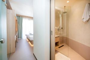 a bathroom with a shower and a bedroom with a bed at Atlantis Lodge in Marsalforn +83 photos