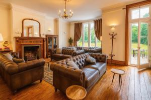 a living room with leather couches and a fireplace at Willingham House Hotel in Willingham +25 photos