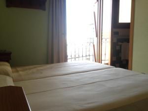 Postel nebo postele na pokoji v ubytování Hostal Aranda