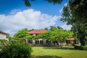a house with a yard with trees at The Forest Chapter by Sayaji Madhai in Sohāgpur