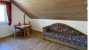 a living room with a couch and a table at Ferienwohnungen Egerer in Riedenburg +6 photos