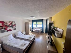 a room with two beds and a table in it at Sara`s Guesthouse Bled in Bled