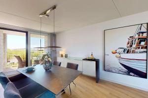 a dining room with a table and a boat on the wall at Port Scaldis 05-012 in Breskens