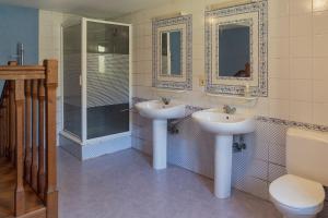a bathroom with two sinks and a shower and a toilet at Maison de la Turbine in Yvoir