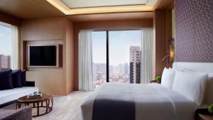 a hotel room with a large bed and a large window at The Ritz-Carlton, Xi'an in Xi'an