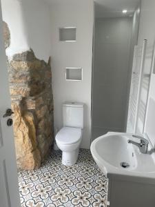 a bathroom with a white toilet and a sink at Casa Borboleta in Chão de Lamas +37 photos