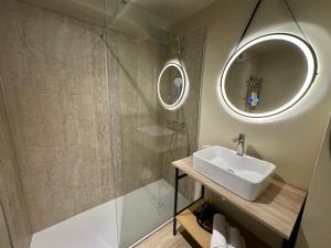 a bathroom with a sink and a mirror at Best Western Hotel de la plage Normandie in Asnelles