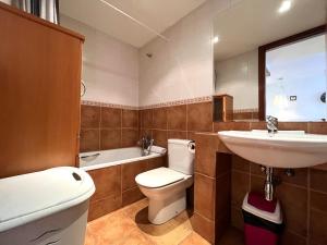 a bathroom with a toilet and a sink and a tub at AC Apartaments Cabirol Incles in Incles +9 photos