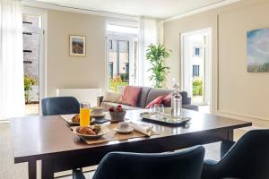 a living room with a wooden table and chairs at Guild Siena Senior Resort & Residence in Siena
