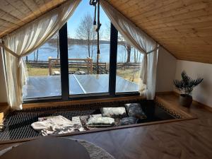 a living room with a large window and a couch at Wrzosowisko Sominki in Sominy