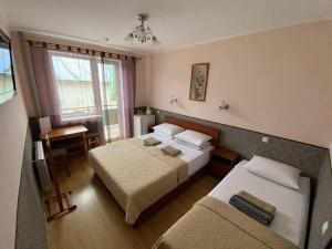 a hotel room with two beds and a couch at SPA Villa Jasmin in Truskavets +46 photos