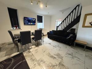 a living room with a couch and a table at Mountain Ash Cottage in Mountain Ash