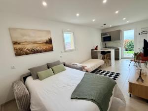 a bedroom with a bed and a living room at Cosy studio with garden in Chevry
