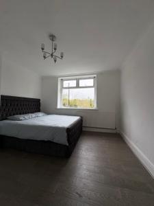 a bedroom with a large bed and a window at Mountain Ash Cottage in Mountain Ash