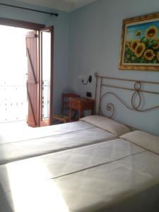 Postel nebo postele na pokoji v ubytování Hostal Aranda