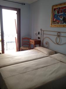 Postel nebo postele na pokoji v ubytování Hostal Aranda