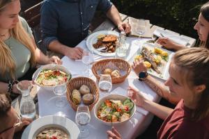 a group of people sitting around a table eating food at Berghotel Hoher Knochen - Ruhe & Natur in Winterberg