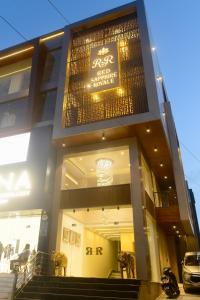 a building with a sign on the side of it at Red Sapphire Royale in Morādābād