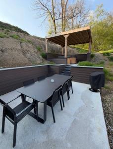 a picnic table and chairs on a patio at Gites Douillets Chalet du Vicomte in Houyet