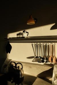 a bunch of utensils on a shelf in a kitchen at Gabanon in Casale Monferrato +43 photos