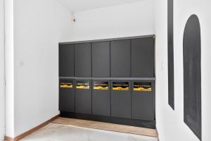 a black locker room with yellow lights in it at YourSuite Studio Premium à Thème in Chaville