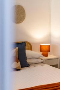 a bedroom with a bed and a table with a lamp at Smeralda 15 in Porto Rotondo