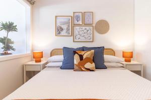 a bedroom with a large bed with two lamps at Smeralda 15 in Porto Rotondo