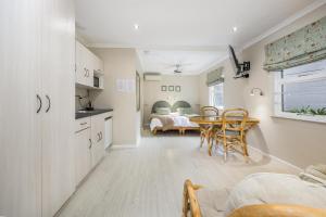 a kitchen and dining room with a table and chairs at Maroela House Guest Accommodation in Bellville