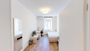 a white room with two beds and a mirror at Mestna Vila Krško in Krško +89 photos
