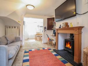 a living room with a fireplace and a tv at 32 Crescent Street in Newtown