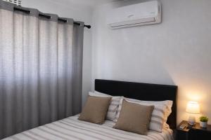 a bedroom with a bed and a window with a heater at Sunlit Retreat Private Flatlet with Solar Power Pool Fast WiFi & Secure Parking in Roodepoort +20 photos