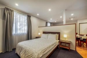 a bedroom with a large bed and a window at Harewood Lodge in Christchurch