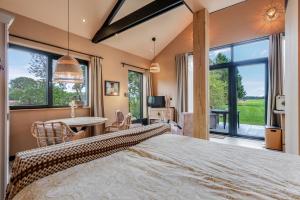 a bedroom with a large bed and a table and chairs at De Witte Kip in Ruinen