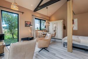 a bedroom with a bed and a dining room at De Witte Kip in Ruinen
