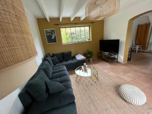 a living room with a couch and a table at Maison avec jardin proche de la plage in Dieppe