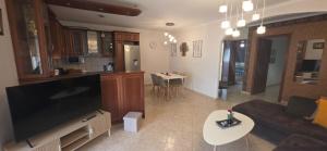 a living room with a large flat screen tv at ARM OV Apartment in Alexandroupoli