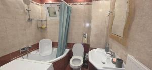 a bathroom with a toilet and a sink and a shower at ARM OV Apartment in Alexandroupoli +12 photos
