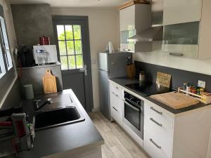 a kitchen with a sink and a stove top oven at Maison avec jardin proche de la plage in Dieppe +1 photo