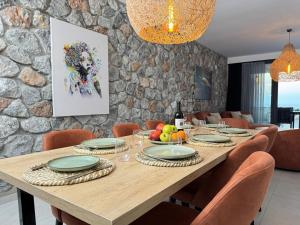 a dining room with a wooden table with chairs at Esentepe Collection Nothern Cyprus Villas & Apartments with Sea View Nothern Cyprus in Pallouriotissa
