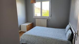 a small bedroom with a bed and a window at Maison grande terrasse Poligny in Poligny