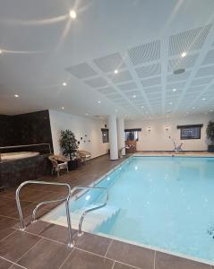 a large swimming pool in a hotel room at Montana Dijon in Dijon